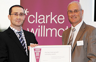 Chris Derret collecting business award